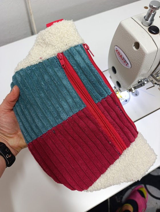 Kremowa puszysta nerka handmade z kieszenią z prążkowanego sztruksu w kolorze bordo i morskim turkusie.